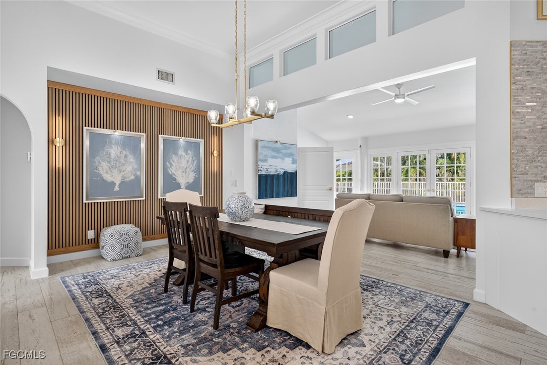 13570 Harbour Ridge Drive Fort Myers, FL 33908 - Photo 10 of 50 a dining room with furniture a chandelier and wooden floor