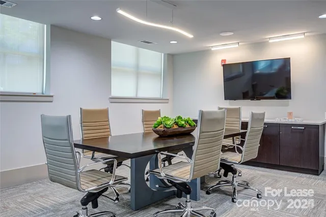 a view of a workspace with furniture and wooden floor