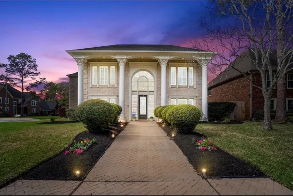 a front view of a house with garden