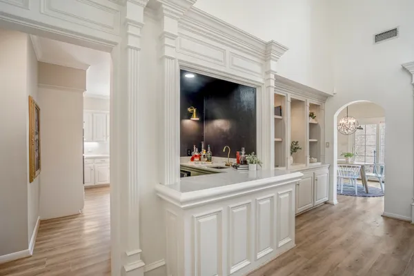 a living room with wooden floor and white doors