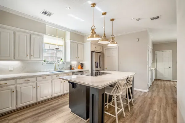 a view of a kitchen counter space a sink and appliances