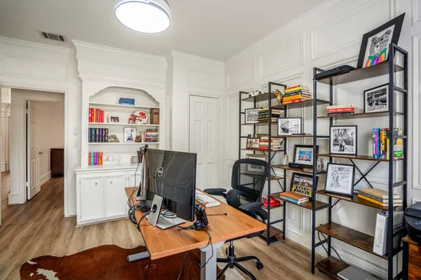 a work room with furniture and wooden floor
