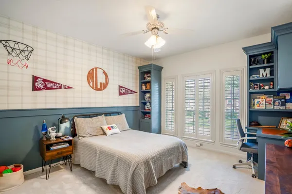 a bedroom with a bed and a book shelf