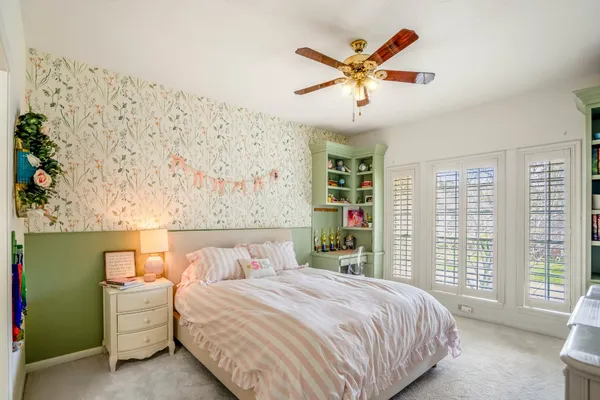 a bedroom with a large bed and a window