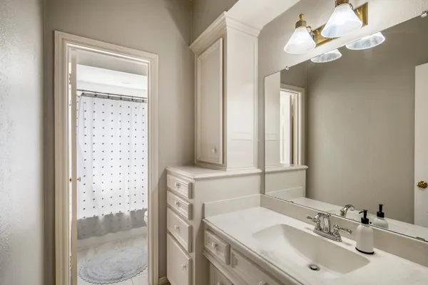 a bathroom with a sink vanity and a mirror