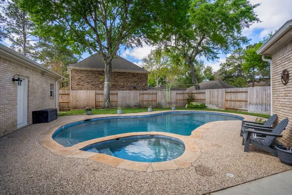 a view of a backyard with swimming pool