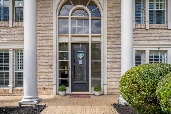 a view of a brick house with large windows