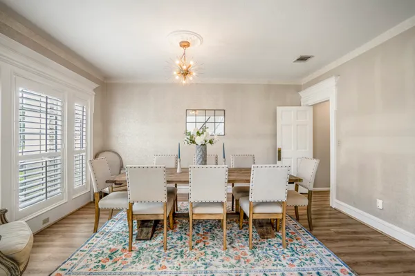 a view of a dining room with furniture and wooden floor