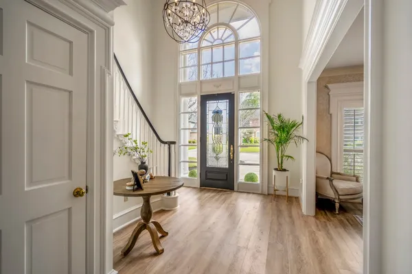 a view of an entryway with wooden floor and a livingroom view