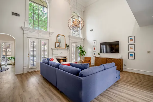a living room with fireplace furniture and a wooden floor