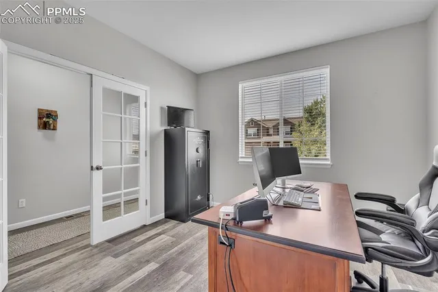 a view of a kitchen with fridge and workspace