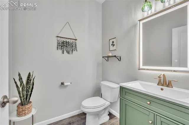 a bathroom with a toilet a sink and mirror
