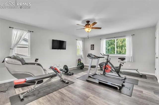 a living room with furniture gym equipment and a window