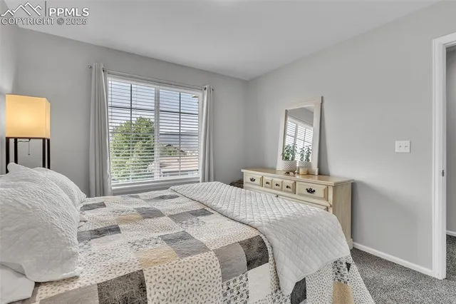 a bedroom with a bed and lamp with window