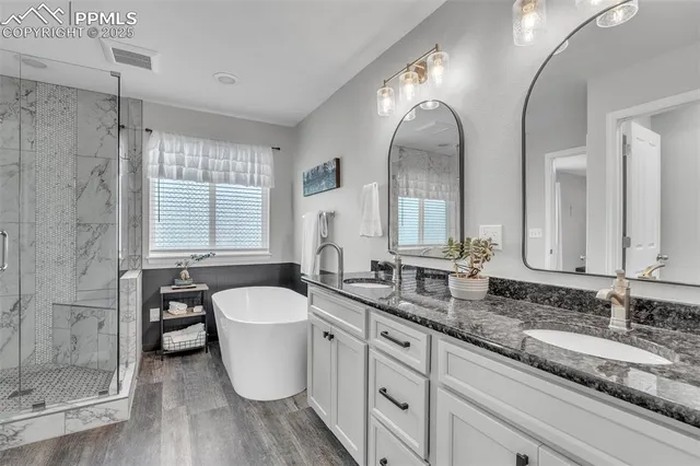 a bathroom with a granite countertop toilet a sink and a mirror