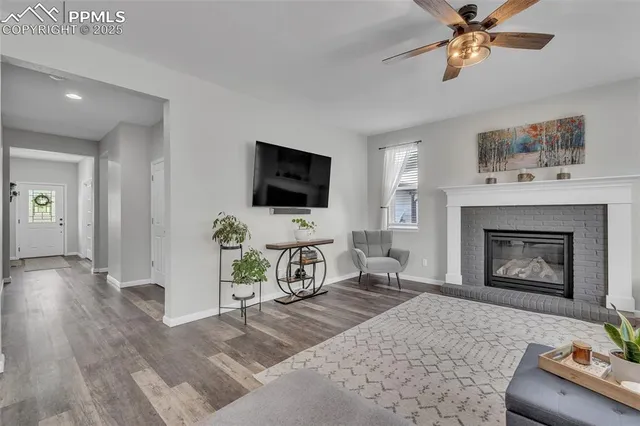 a living room with furniture a fireplace and a flat screen tv