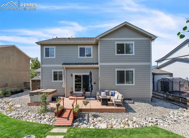 a view of a backyard with sitting area