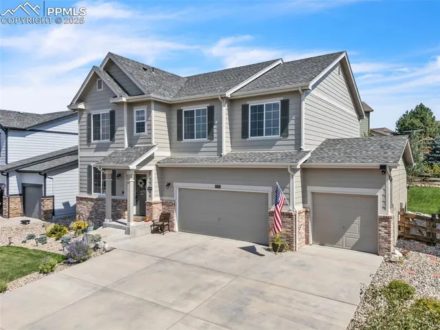 a front view of a house with a yard and outdoor seating
