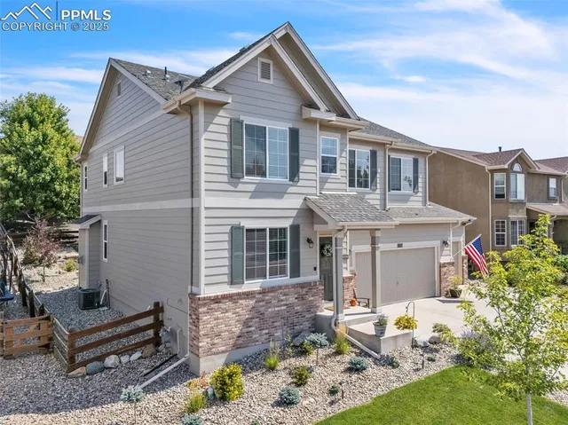 an aerial view of residential houses with outdoor space and ocean view