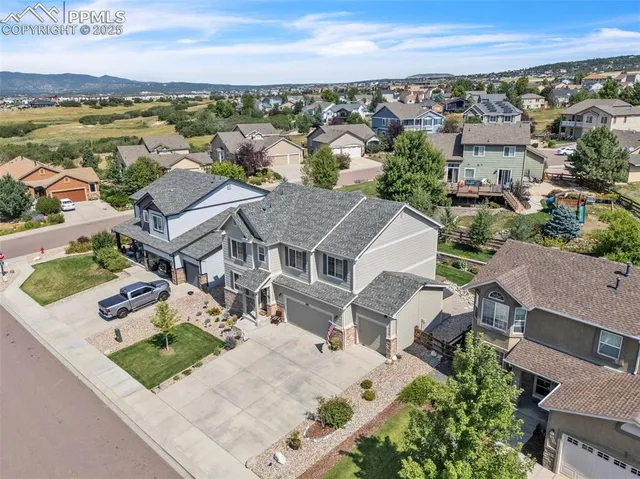 an aerial view of residential houses with outdoor space