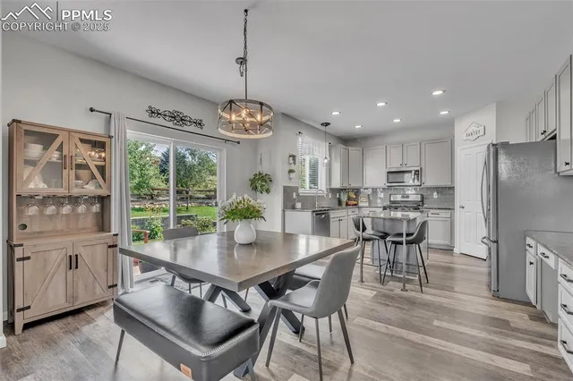 a view of a dining room with furniture window and wooden floor