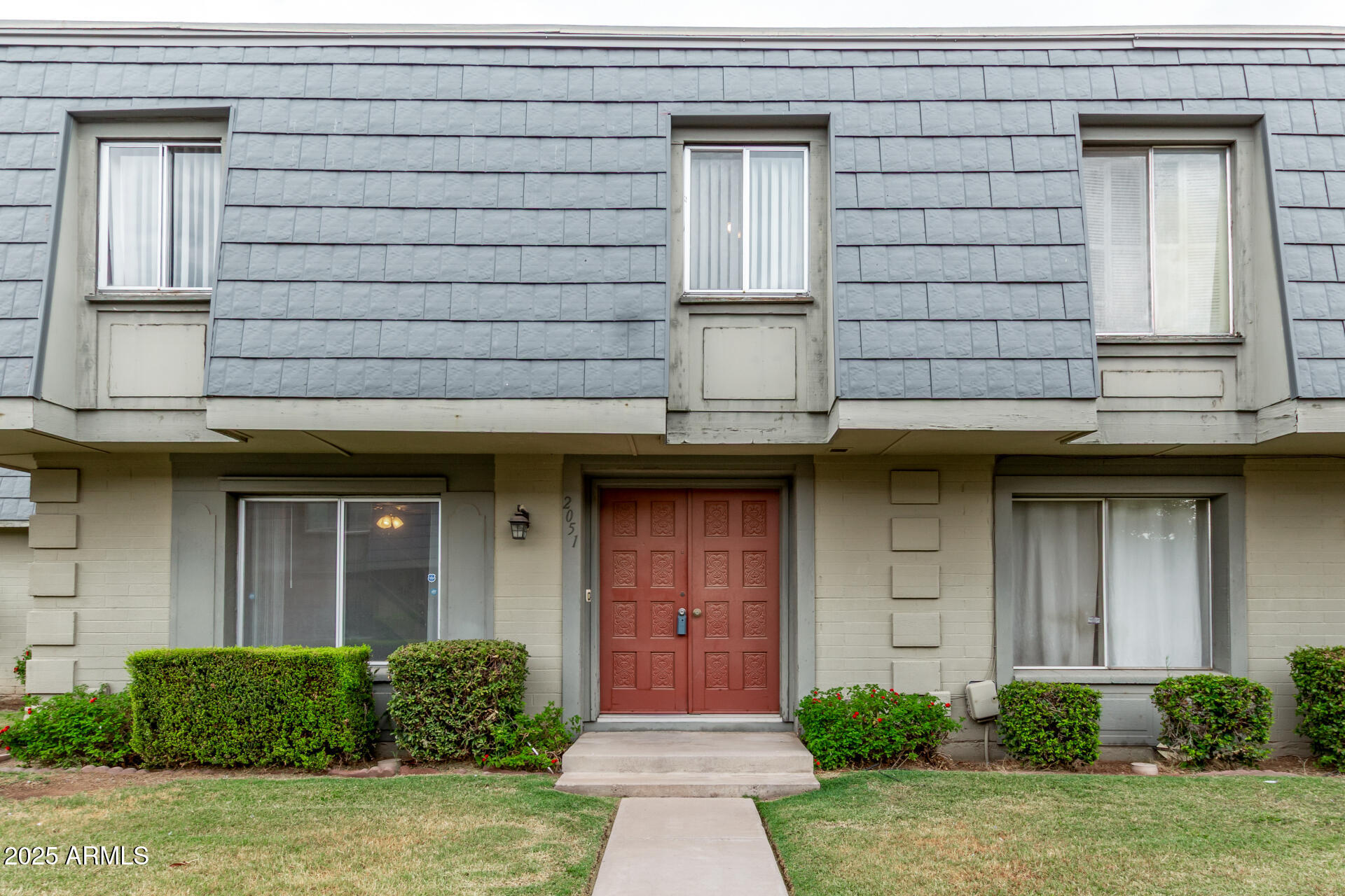 a front view of a house with garden