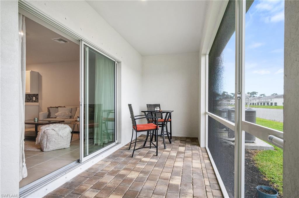 15070 Wildflower Circle Naples, FL 34119 - Photo 11 of 22 a balcony with furniture and a gate