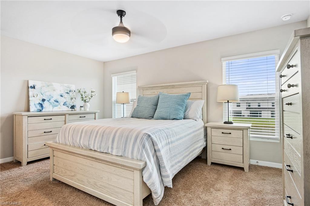 15070 Wildflower Circle Naples, FL 34119 - Photo 15 of 22 a bedroom with a large bed and a window