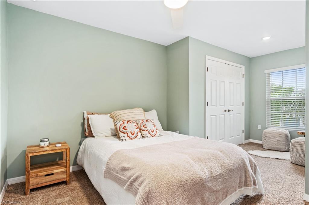 15070 Wildflower Circle Naples, FL 34119 - Photo 18 of 22 a bedroom with a bed and a window