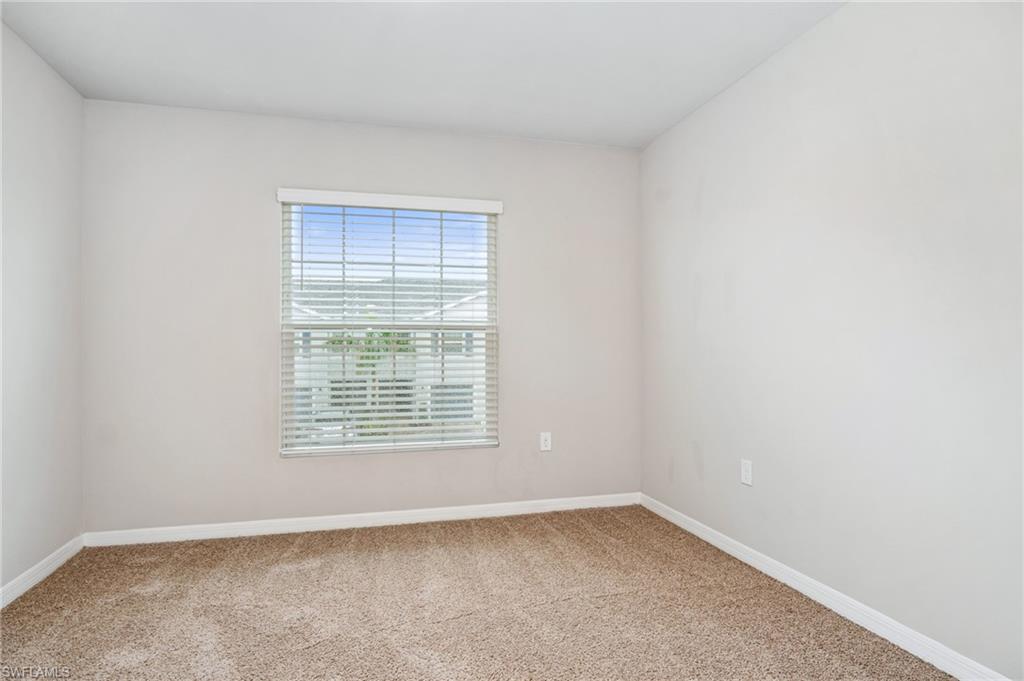 15070 Wildflower Circle Naples, FL 34119 - Photo 20 of 22 a view of an empty room with a window