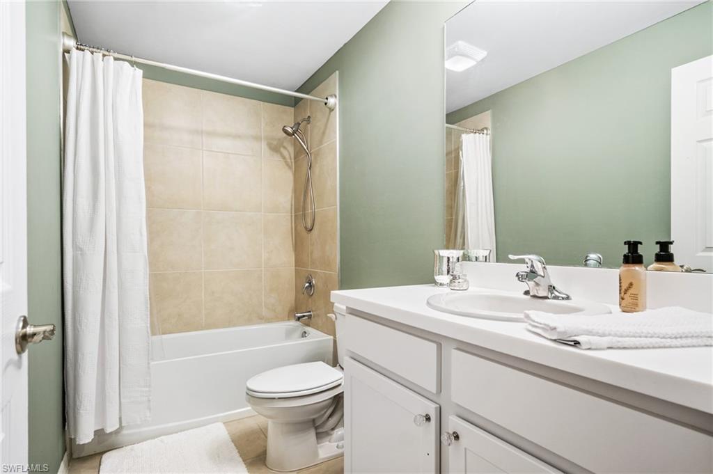 15070 Wildflower Circle Naples, FL 34119 - Photo 22 of 22 a bathroom with a sink a toilet and shower