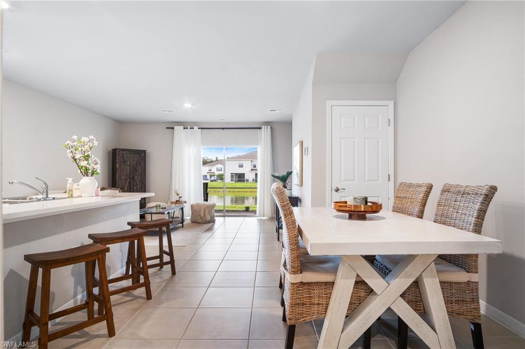 15070 Wildflower Circle Naples, FL 34119 - Photo 6 of 22 a view of a dining room with furniture and a window
