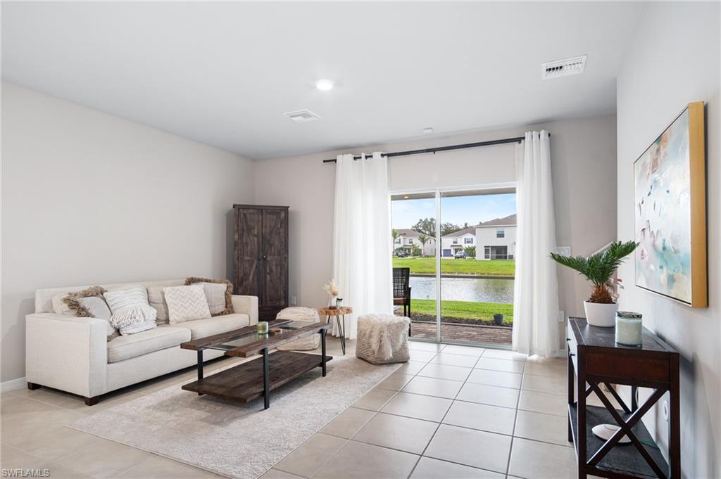 15070 Wildflower Circle Naples, FL 34119 - Photo 8 of 22 a living room with furniture and a large window