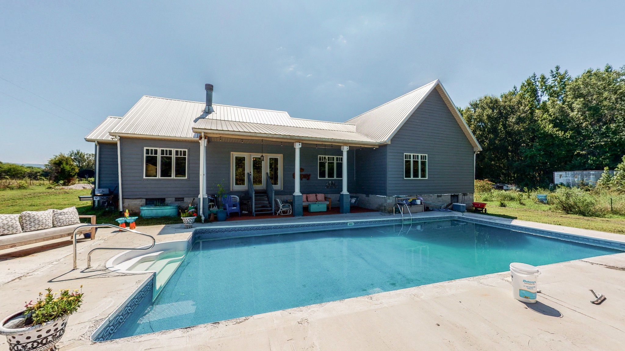 729 Dabbsy Ford Road Decherd, TN 37324 - Photo 6 of 25 a front view of a house with swimming pool having outdoor seating