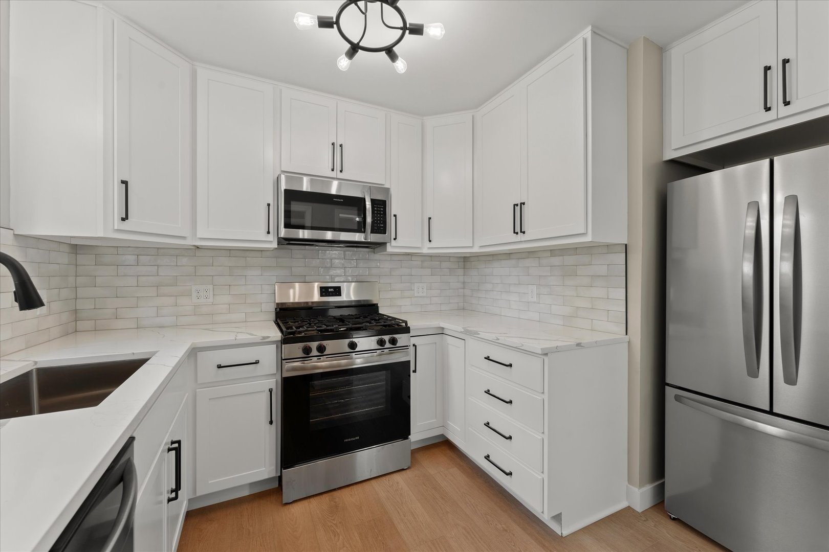305 South Fair Street Champaign, IL 61821 - Photo 13 of 41 a kitchen with white cabinets and stainless steel appliances
