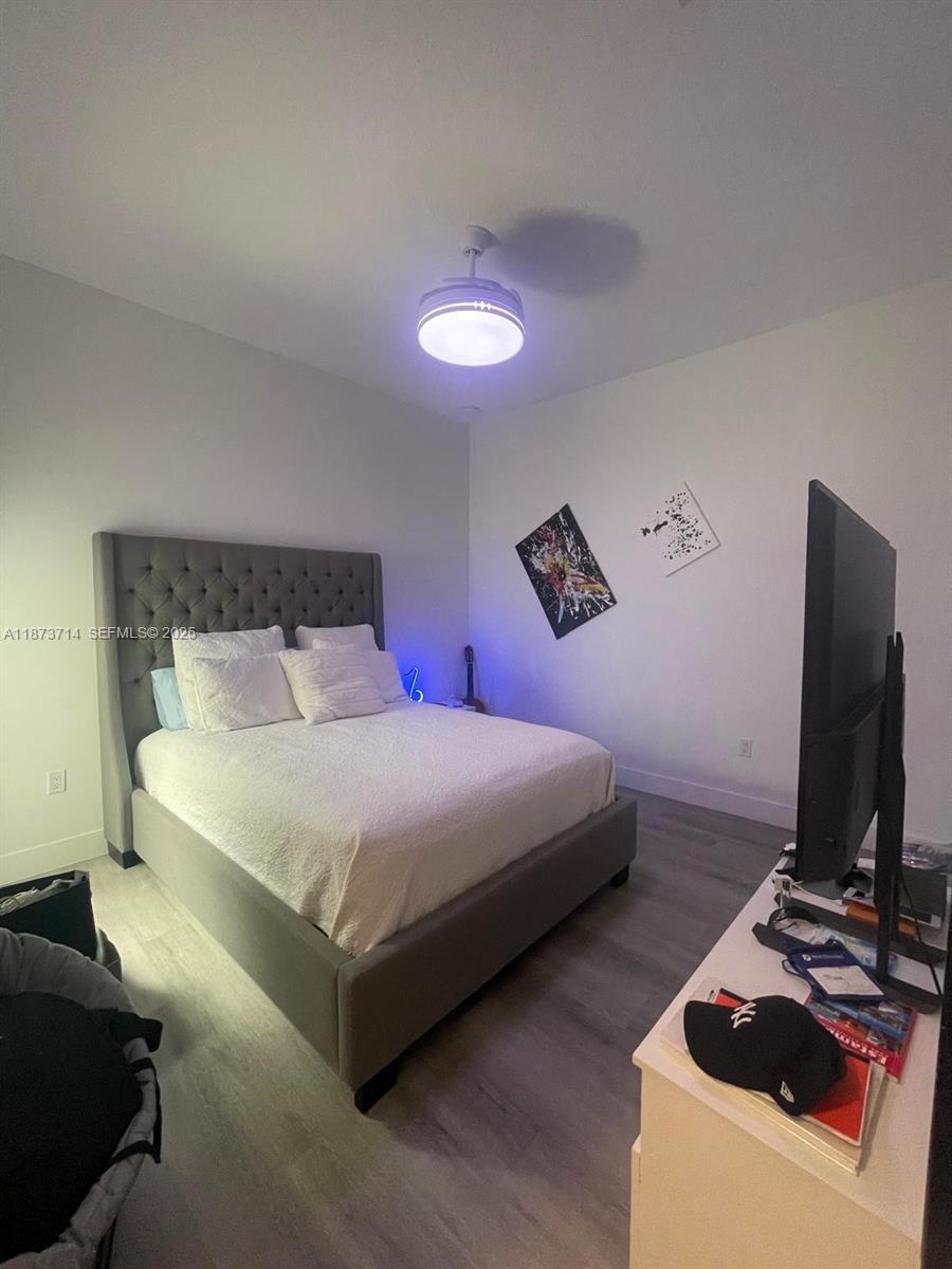 17267 Windy Pointe Lane Boca Raton, FL 33496 - Photo 13 of 47 a bedroom with a bed and a flat screen tv