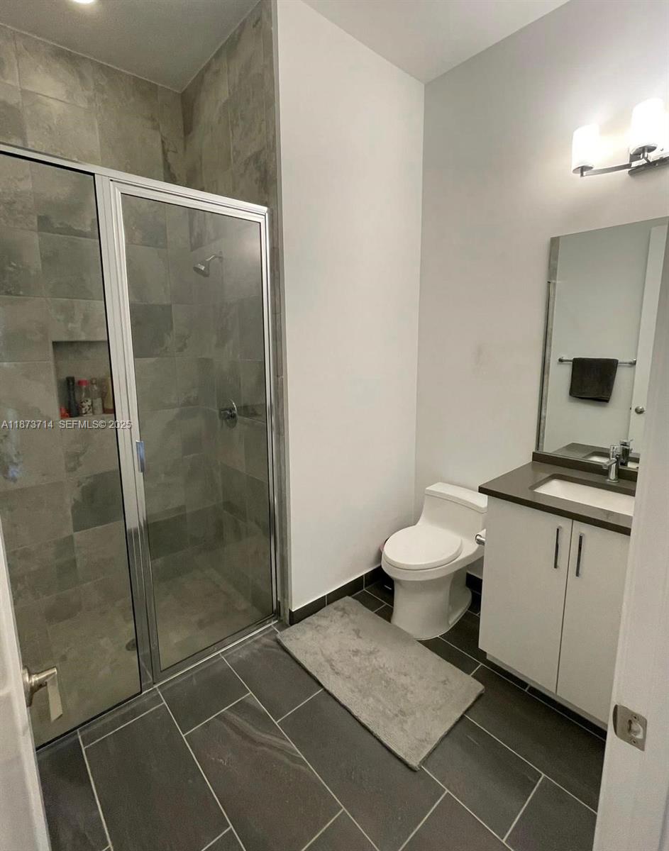 17267 Windy Pointe Lane Boca Raton, FL 33496 - Photo 15 of 47 a bathroom with a toilet and a shower