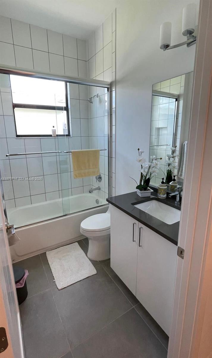 17267 Windy Pointe Lane Boca Raton, FL 33496 - Photo 17 of 47 a bathroom with a double vanity sink toilet and shower