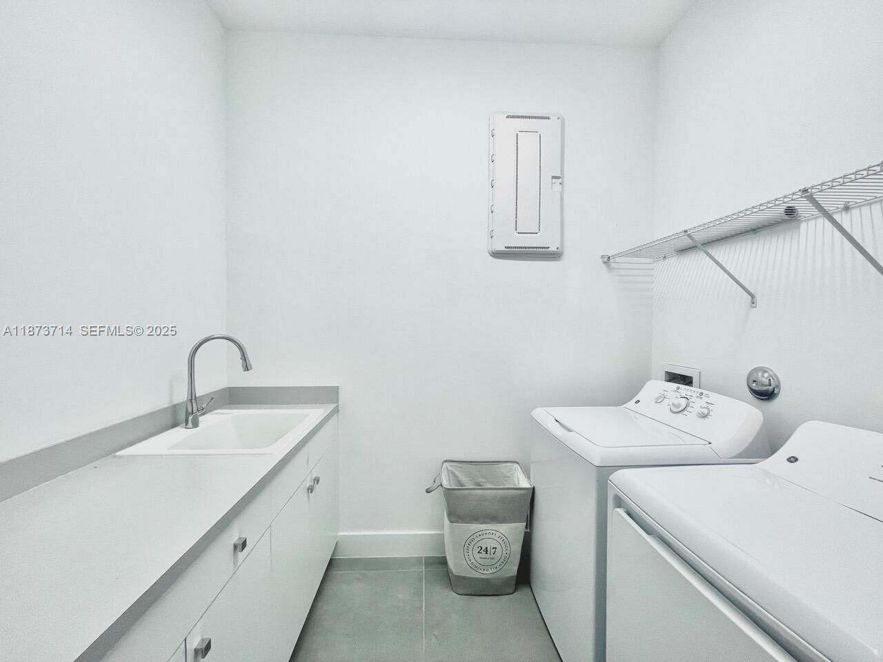 17267 Windy Pointe Lane Boca Raton, FL 33496 - Photo 18 of 47 a utility room with dryer and washer