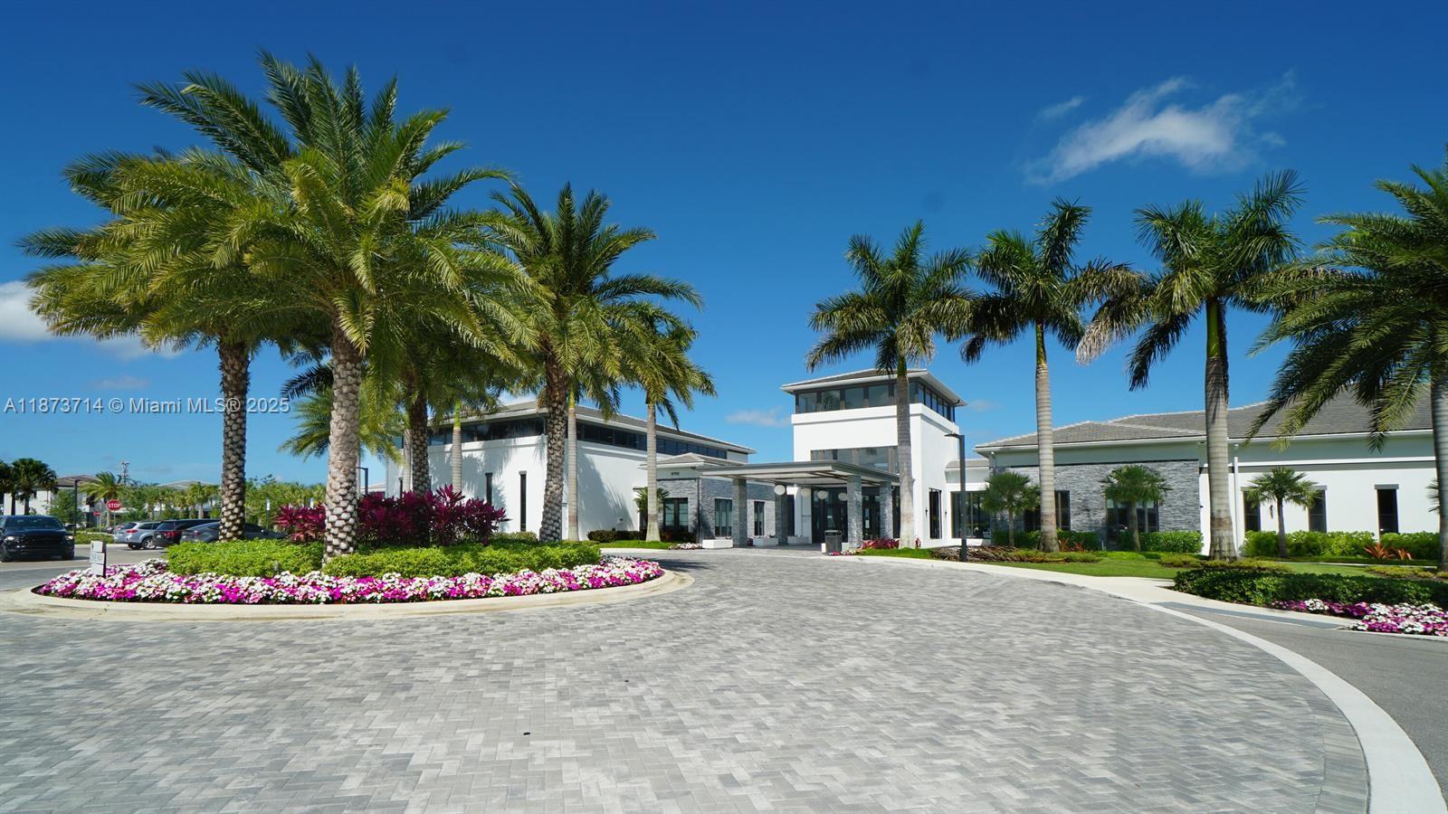 17267 Windy Pointe Lane Boca Raton, FL 33496 - Photo 38 of 47 a front view of multi story residential apartment building with yard and sign board