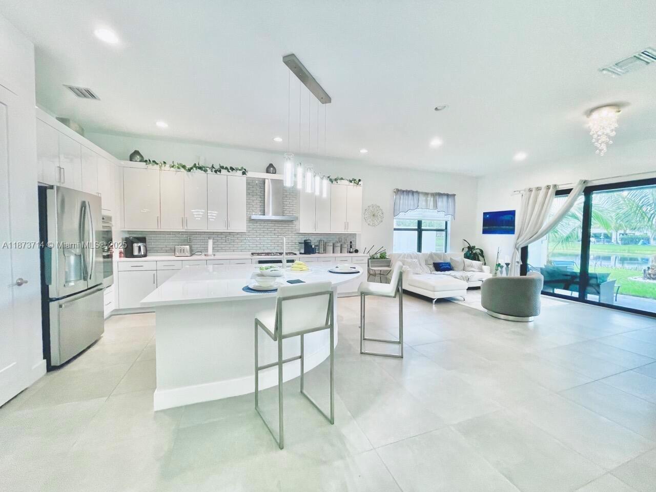 17267 Windy Pointe Lane Boca Raton, FL 33496 - Photo 5 of 47 a kitchen with counter top space cabinets and stainless steel appliances