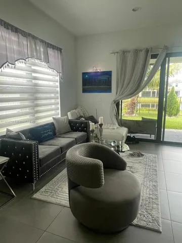 a living room with furniture and a large window