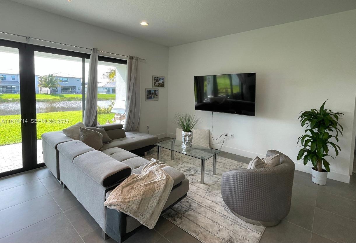17267 Windy Pointe Lane Boca Raton, FL 33496 - Photo 8 of 47 a living room with furniture and a flat screen tv