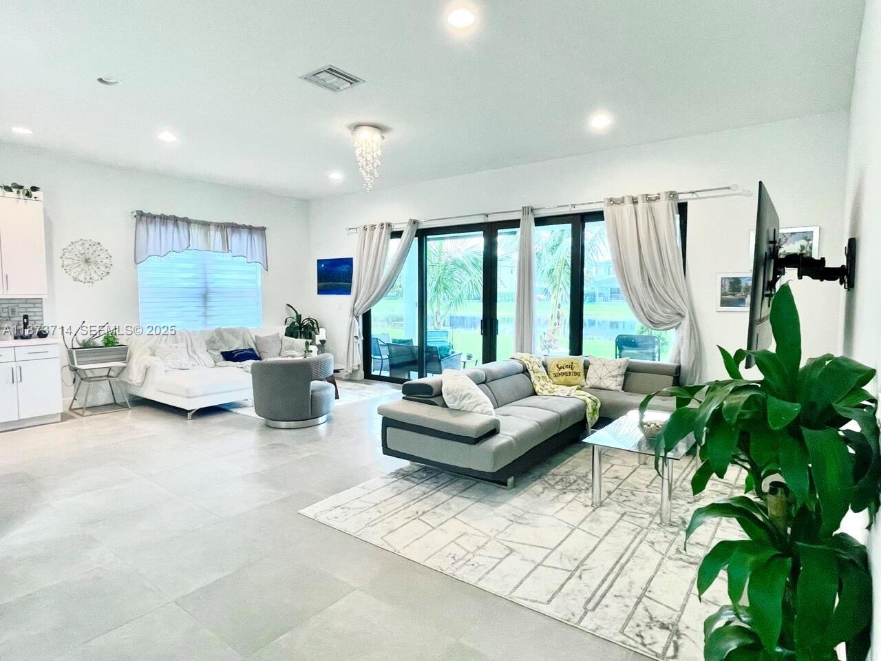 17267 Windy Pointe Lane Boca Raton, FL 33496 - Photo 9 of 47 a living room with furniture and a large window
