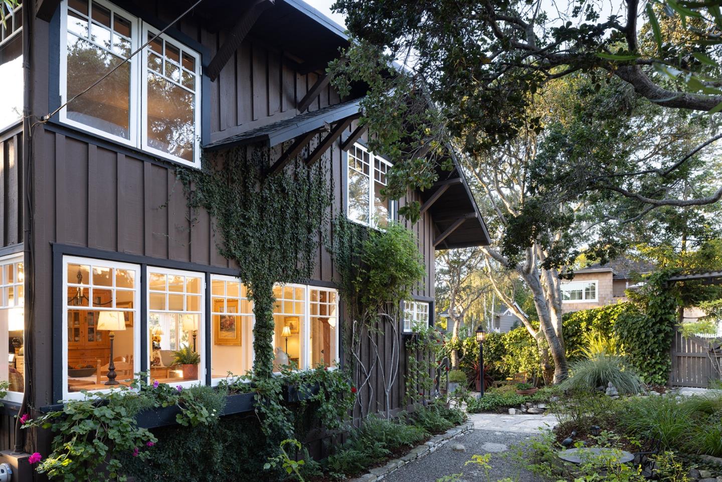 a view of backyard with potted plants and wooden fence