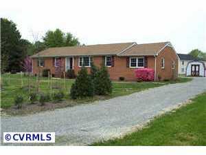 9312 Reams Road Richmond, VA 23236 - Photo 3 of 10 a front view of a house with a yard and garage