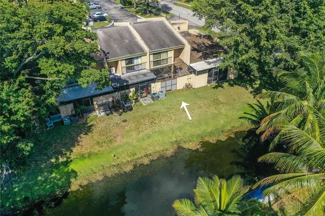 a aerial view of a house with a yard basket ball court and outdoor seating
