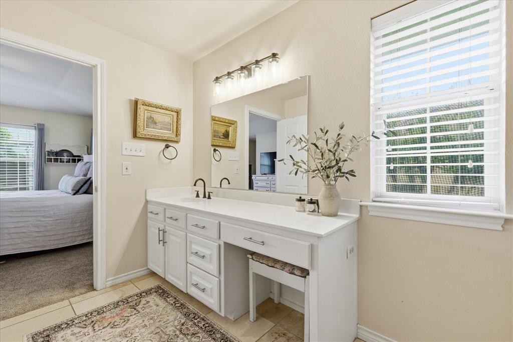 202 Colonial Heights Sanger, TX 76266 - Photo 17 of 27 a spacious bathroom with a double vanity sink and a mirror