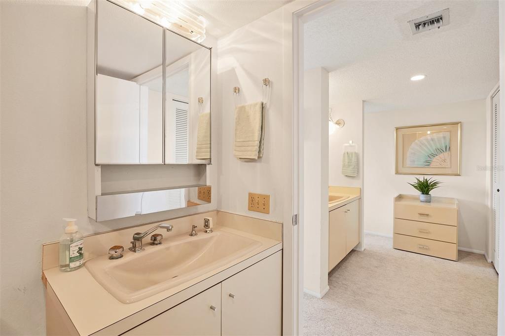 6285 Midnight Pass Road, Unit 403 Sarasota, FL 34242 - Photo 18 of 51 a bathroom with a sink and a mirror