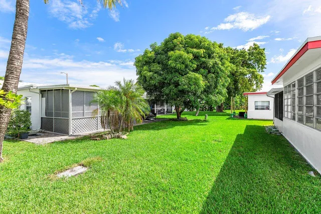 a front view of a house with a garden and yard